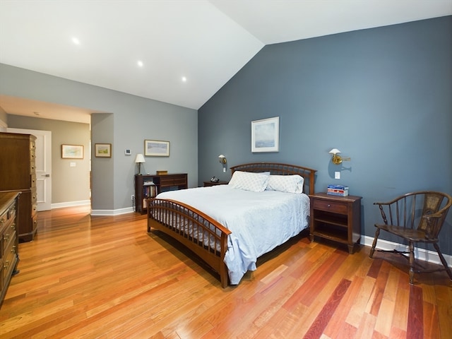 bedroom with vaulted ceiling and hardwood / wood-style floors