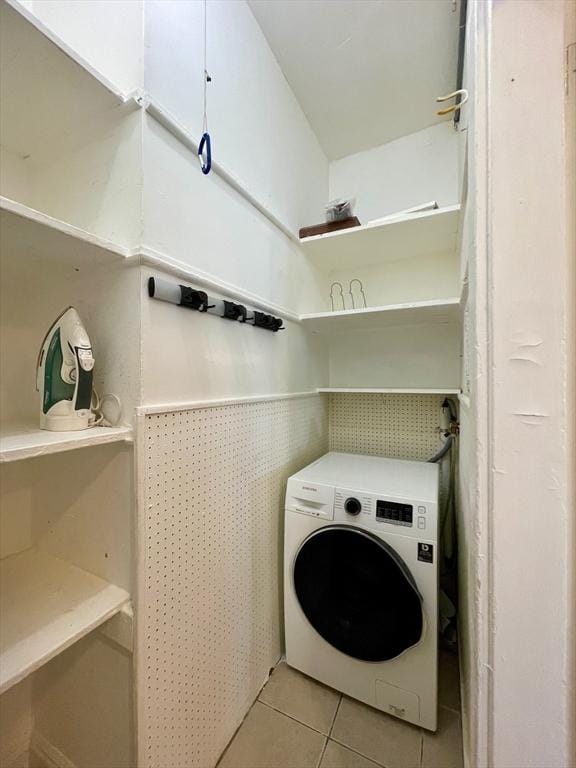 132 Sewall Ave Unit B, Brookline, MA 02446 - laundry room featuring washer / dryer, light tile patterned floors, and a wainscoted wall