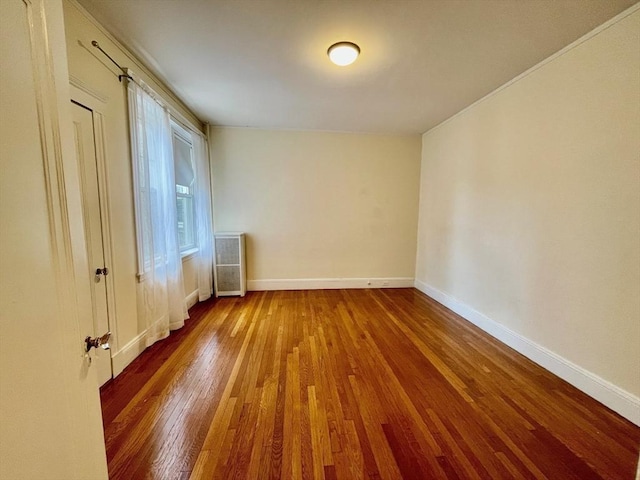 132 Sewall Ave Unit B, Brookline, MA 02446 - spare room featuring wood finished floors and radiator heating unit