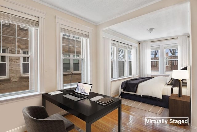 132 Sewall Ave Unit B, Brookline, MA 02446 - bedroom with a textured ceiling, wood finished floors, ornamental molding, and an office area