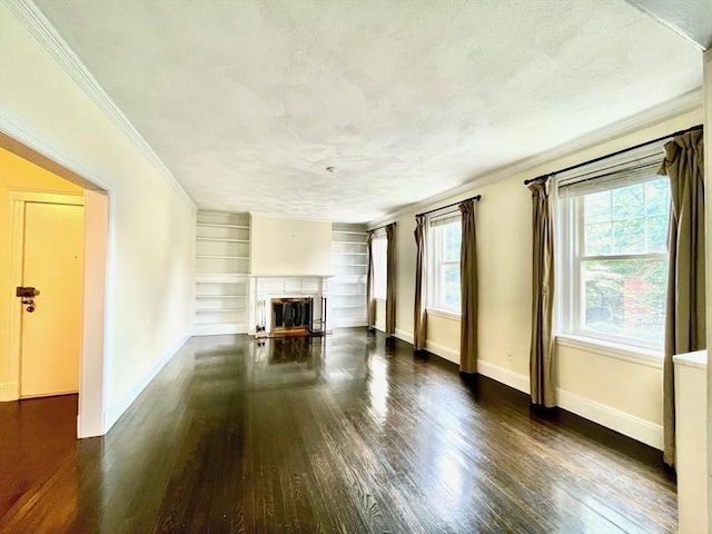 132 Sewall Ave Unit B, Brookline, MA 02446 - unfurnished living room with a textured ceiling, ornamental molding, wood finished floors, a glass covered fireplace, and built in shelves