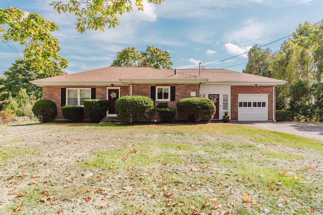 single story home featuring a front lawn and a garage