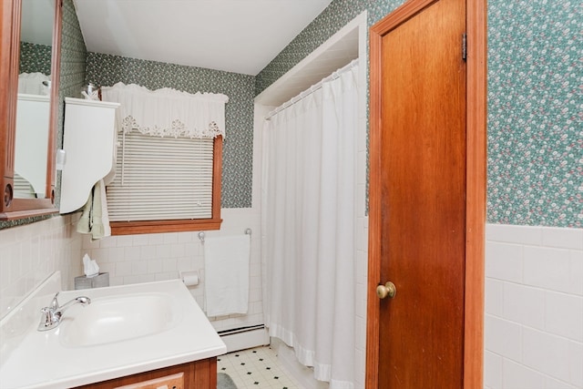 bathroom featuring vanity, tile walls, baseboard heating, and curtained shower