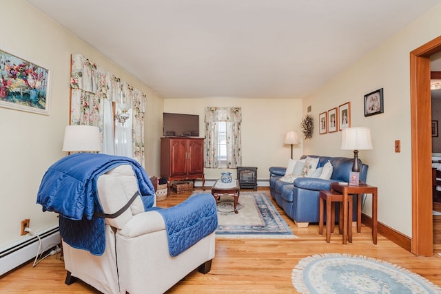 living room with a baseboard radiator and light hardwood / wood-style floors