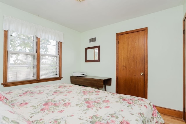 bedroom with light wood-type flooring