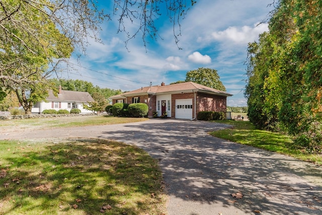 ranch-style home with a front yard and a garage