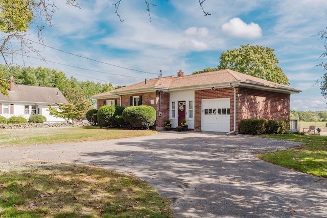 ranch-style home with a garage and a front yard