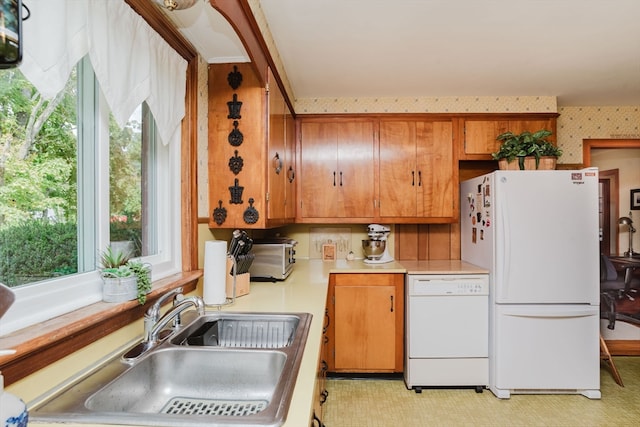 kitchen featuring white appliances and sink