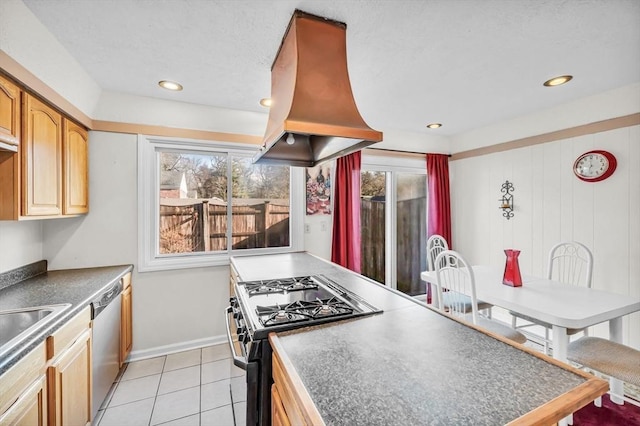 kitchen featuring island exhaust hood, light tile patterned floors, and stainless steel appliances