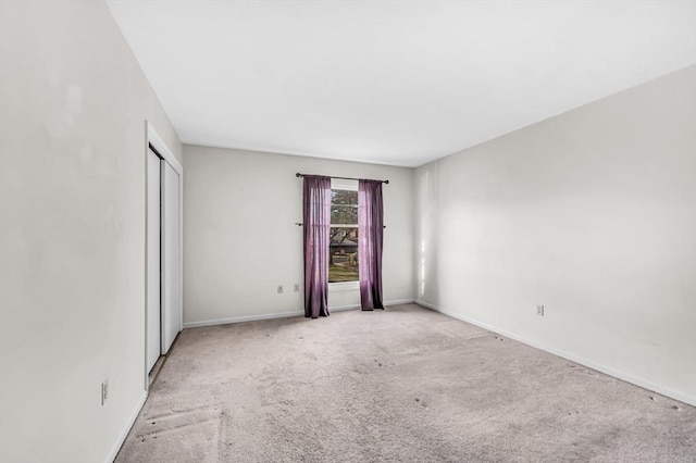 empty room featuring light colored carpet