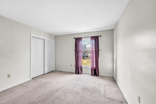 unfurnished room with light colored carpet