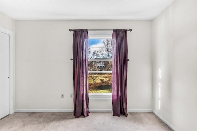 spare room featuring light colored carpet