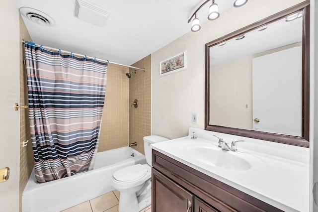 full bathroom with tile patterned flooring, vanity, toilet, and shower / bath combo with shower curtain