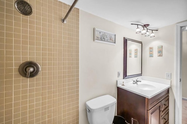 bathroom featuring a tile shower and vanity