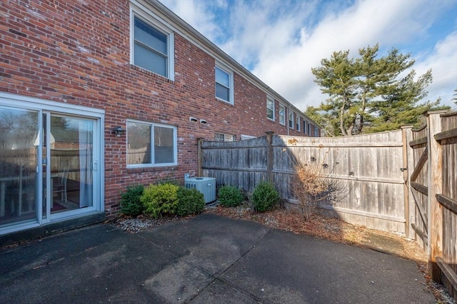 exterior space with cooling unit and a patio