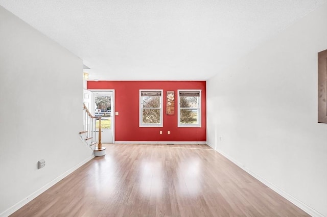 entryway featuring light hardwood / wood-style floors and a textured ceiling