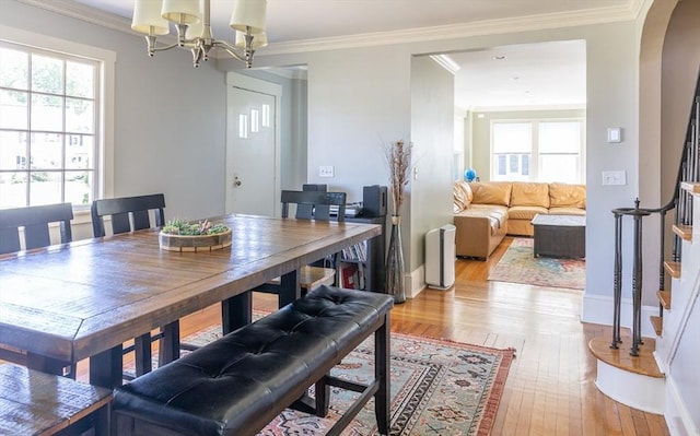 103 Maple Rd, Longmeadow, MA 01106 - dining space featuring light wood-style flooring, stairs, a chandelier, baseboards, and ornamental molding