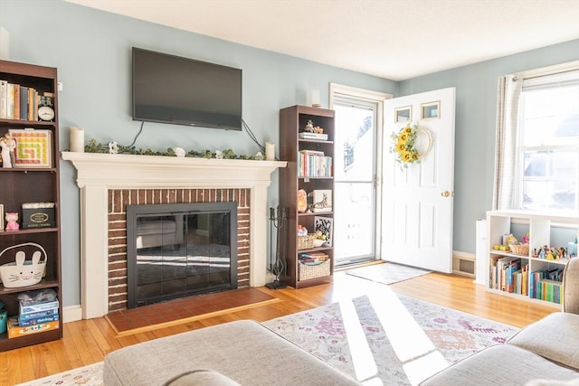 103 Maple Rd, Longmeadow, MA 01106 - living room featuring plenty of natural light, a fireplace, and wood finished floors