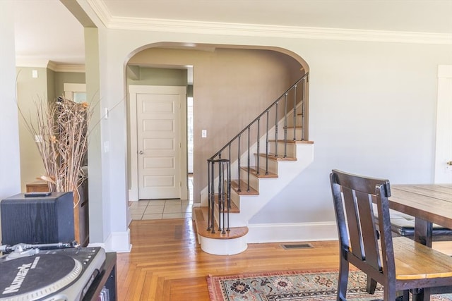 103 Maple Rd, Longmeadow, MA 01106 - stairway with arched walkways, baseboards, crown molding, and wood finished floors