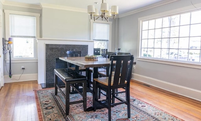 103 Maple Rd, Longmeadow, MA 01106 - dining area with healthy amount of natural light, wood-type flooring, a chandelier, and crown molding