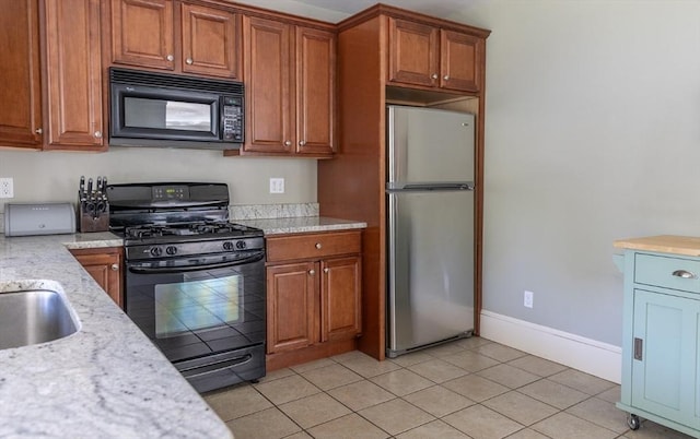 103 Maple Rd, Longmeadow, MA 01106 - kitchen featuring black appliances, brown cabinetry, baseboards, and light tile patterned flooring