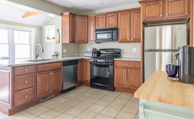 103 Maple Rd, Longmeadow, MA 01106 - kitchen featuring black appliances, a sink, brown cabinets, a peninsula, and lofted ceiling