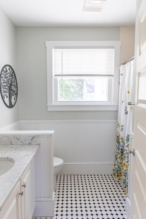 103 Maple Rd, Longmeadow, MA 01106 - full bathroom featuring vanity, a wainscoted wall, toilet, and a shower with curtain