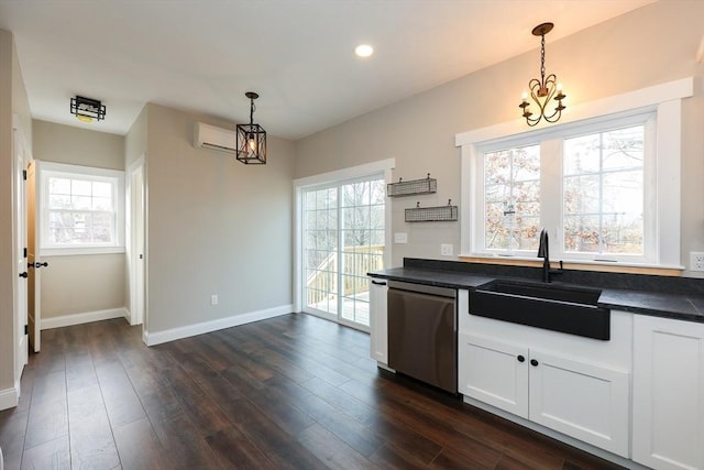 kitchen with dark hardwood / wood-style flooring, dishwasher, pendant lighting, white cabinets, and sink