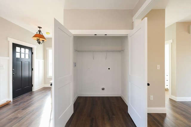 clothes washing area featuring dark hardwood / wood-style floors and hookup for an electric dryer