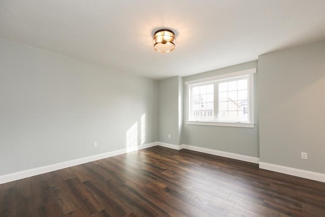 spare room with dark wood-type flooring