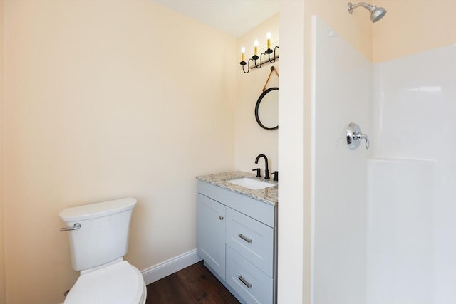 bathroom with wood-type flooring, toilet, and vanity