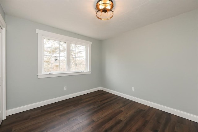 unfurnished room with dark hardwood / wood-style floors