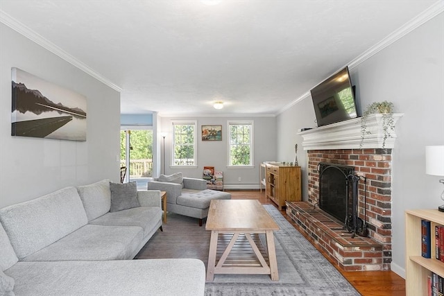 living area with a brick fireplace, wood finished floors, ornamental molding, a baseboard radiator, and baseboards