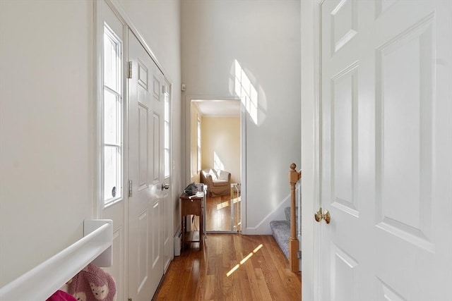 hall featuring wood finished floors and stairway