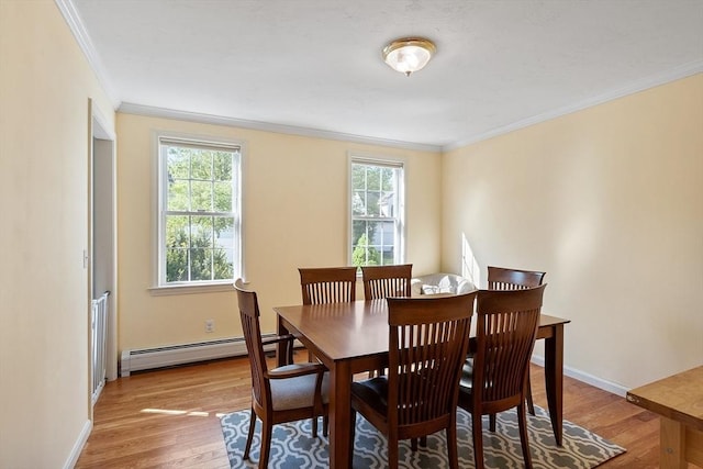dining area with a baseboard radiator, ornamental molding, light wood finished floors, and baseboards