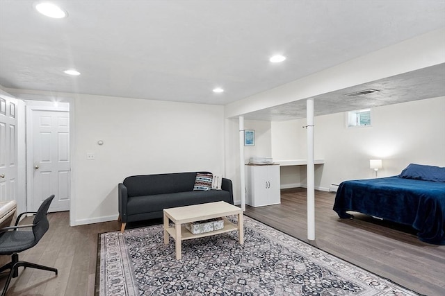 bedroom featuring wood finished floors, baseboards, and recessed lighting