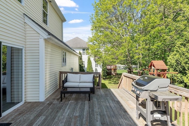 wooden deck with outdoor lounge area and grilling area