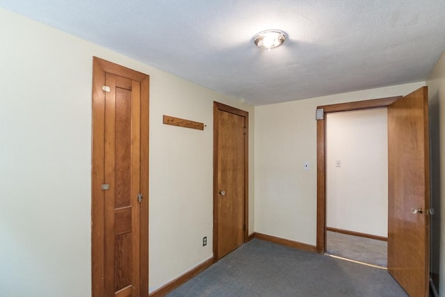 unfurnished bedroom with baseboards, carpet flooring, and a closet