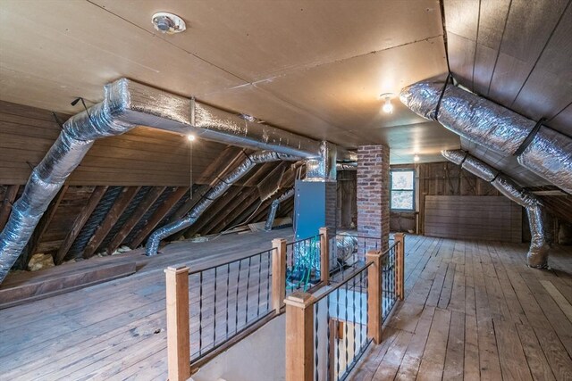 unfinished attic with an upstairs landing
