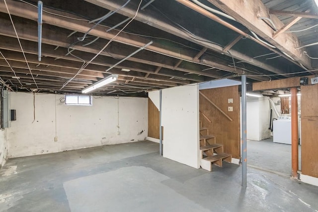 below grade area featuring washer / clothes dryer and stairs