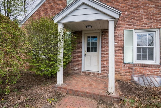 property entrance with brick siding