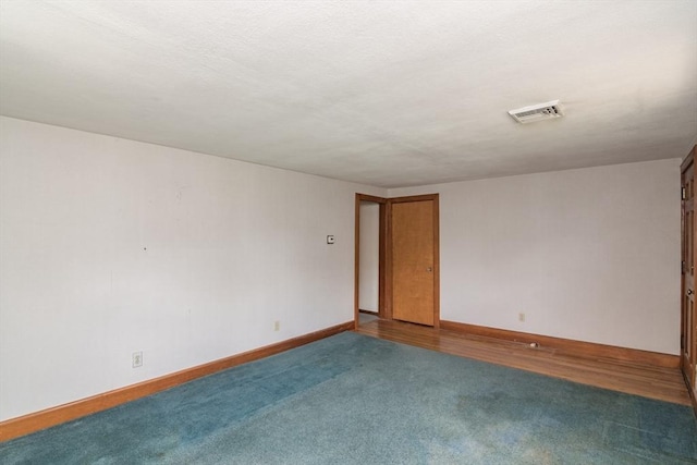 unfurnished room with baseboards, visible vents, and carpet floors