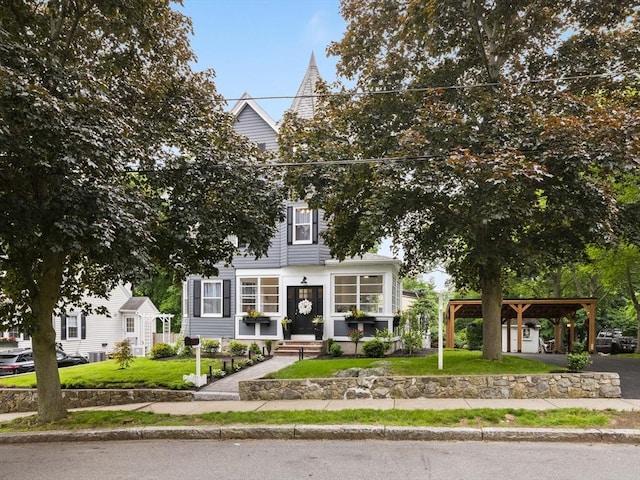 34 Rockland St, Melrose, MA 02176 - view of property hidden behind natural elements featuring a front lawn