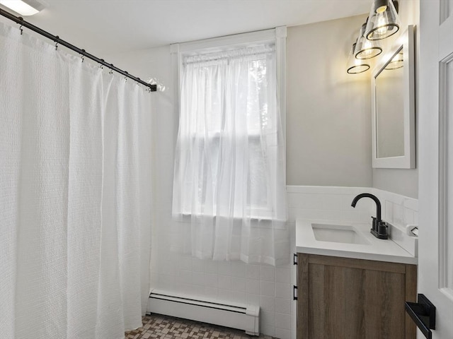 34 Rockland St, Melrose, MA 02176 - full bathroom with a baseboard heating unit, vanity, tile walls, and a shower with curtain