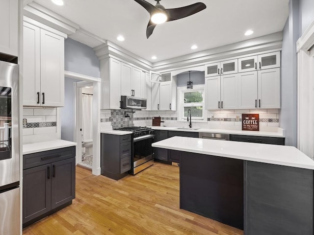 34 Rockland St, Melrose, MA 02176 - kitchen with stainless steel appliances, a ceiling fan, light countertops, tasteful backsplash, and recessed lighting