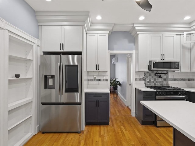 34 Rockland St, Melrose, MA 02176 - kitchen with stainless steel appliances, light countertops, white cabinets, tasteful backsplash, and recessed lighting