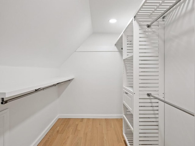 34 Rockland St, Melrose, MA 02176 - walk in closet with light wood-type flooring and vaulted ceiling