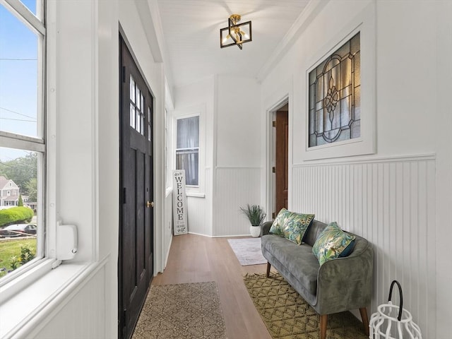 34 Rockland St, Melrose, MA 02176 - entryway featuring wood finished floors, healthy amount of natural light, a wainscoted wall, and crown molding