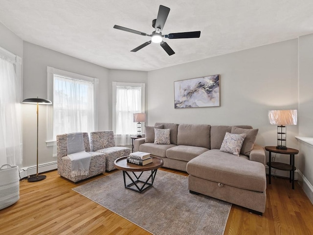 34 Rockland St, Melrose, MA 02176 - living area featuring a baseboard radiator, wood finished floors, and a ceiling fan