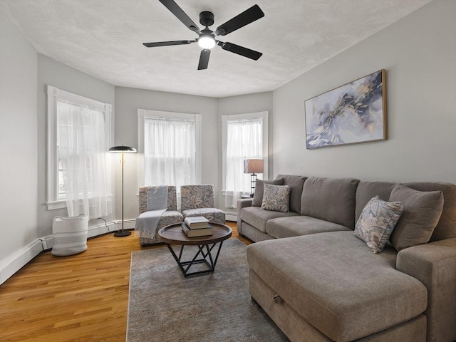 34 Rockland St, Melrose, MA 02176 - living area with a ceiling fan, light wood finished floors, and baseboard heating